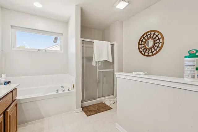 a bathroom with a bathtub and a shower