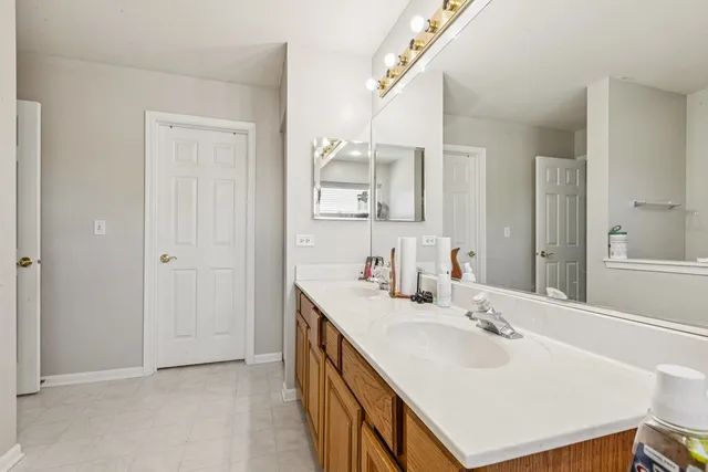 a bathroom with a sink double vanity and a mirror