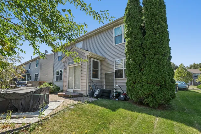 a view of a house with backyard and sitting area