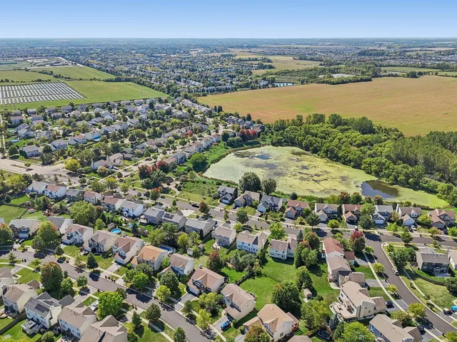 an aerial view of a city and lake view