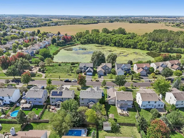 an aerial view of lake and residential houses with outdoor space and lake view