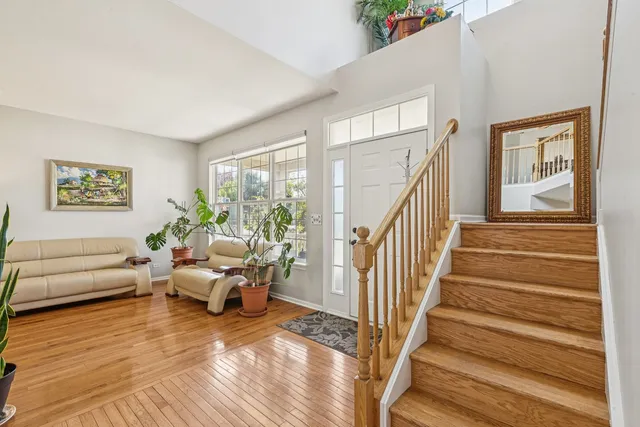 a living room with furniture and stairs