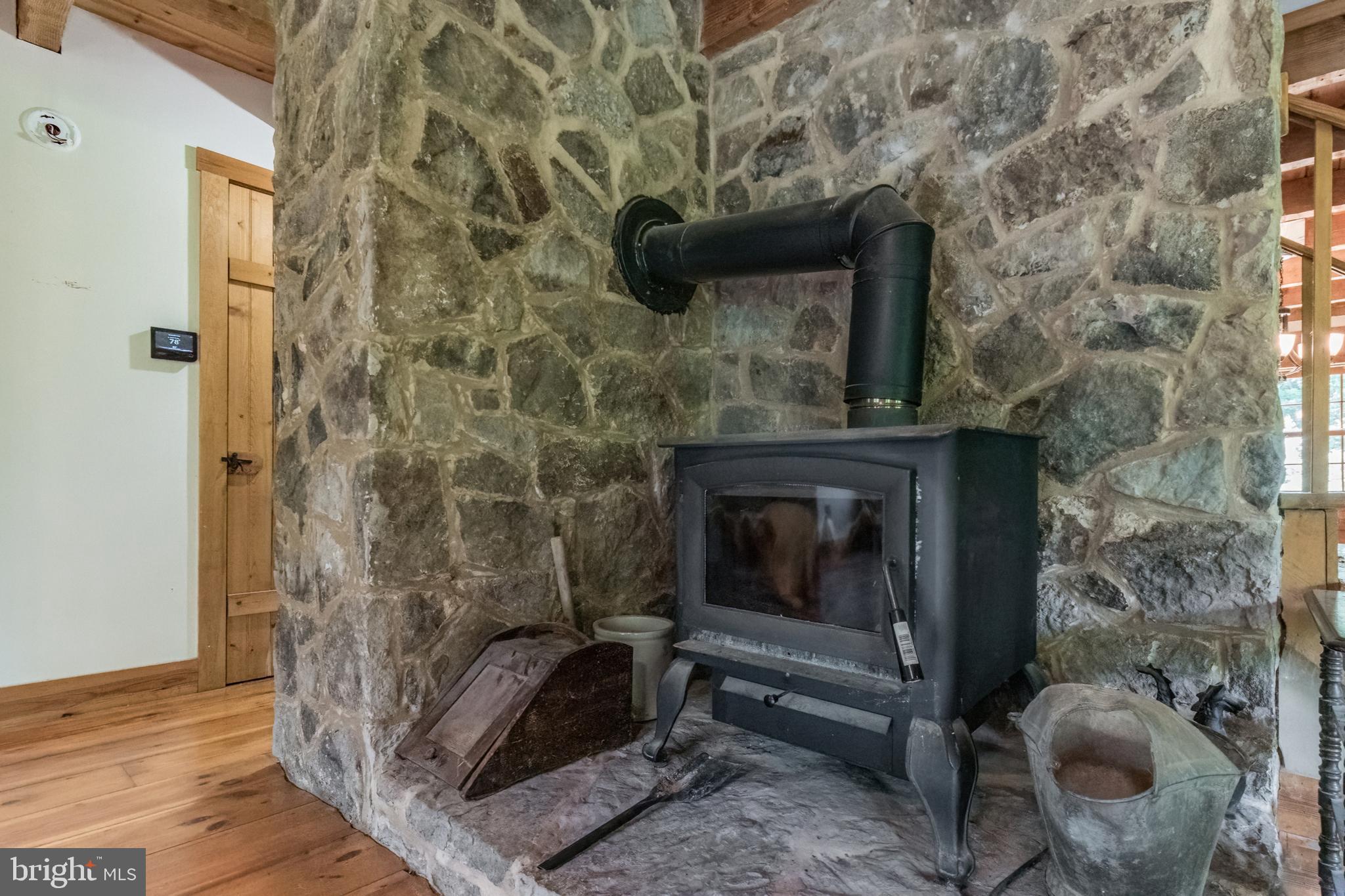 2756 Trough Road Shepherdstown, WV 25443 - Photo 35 of 42 stone hearth in living room with woodstove hookup