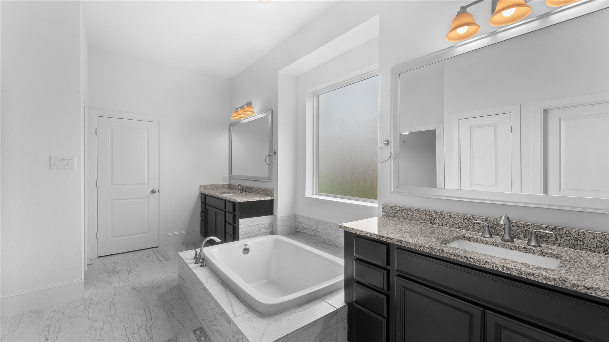 32001 Birch Briar Court Spring, TX 77386 - Photo 24 of 48 Elegant primary bath with dual granite vanities, soaking tub, oversized mirror, and designer lighting.