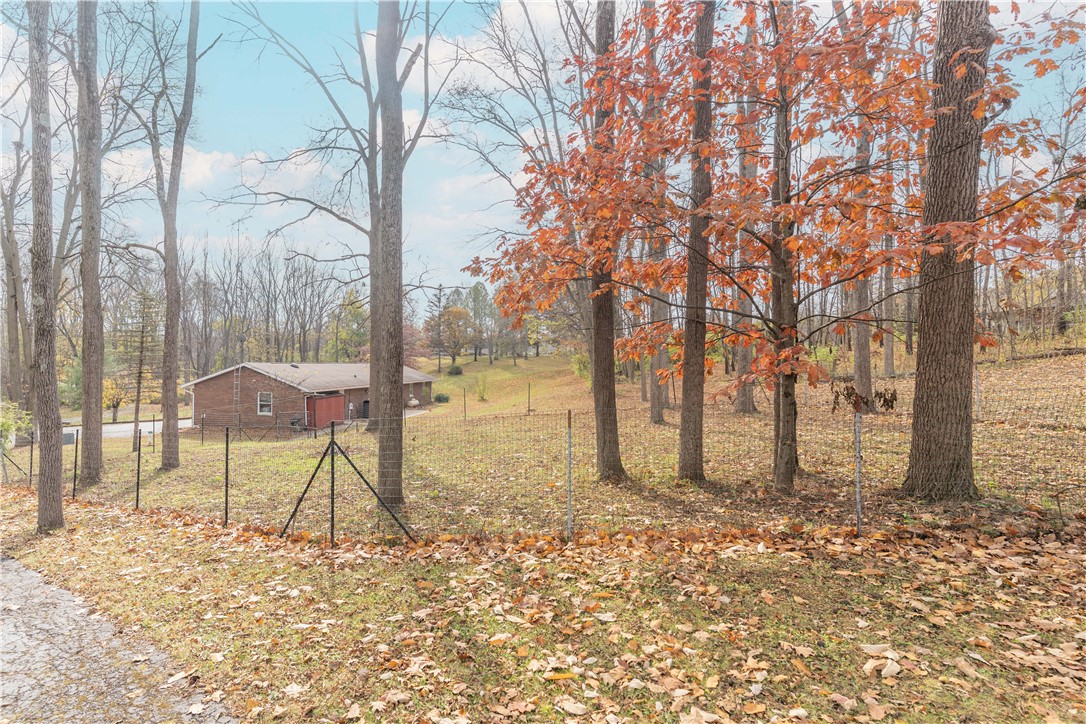 18333 Lefevre Number 2 Road Sidney, OH 45365 - Photo 12 of 25 This tranquil outdoor space offers a peaceful setting surrounded by mature trees.