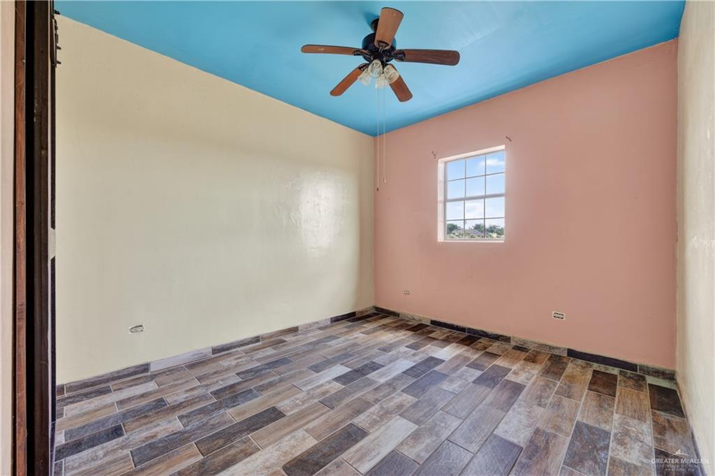 1424 North Sky Soldier Road Weslaco, TX 78596 - Photo 21 of 33 a view of room with window and ceiling fan