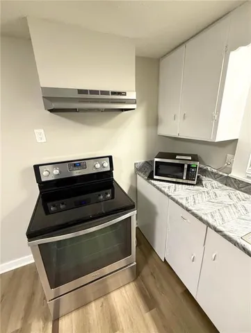 a stove top oven sitting inside of a kitchen