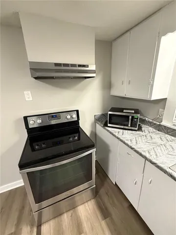 a stove top oven sitting inside of a kitchen