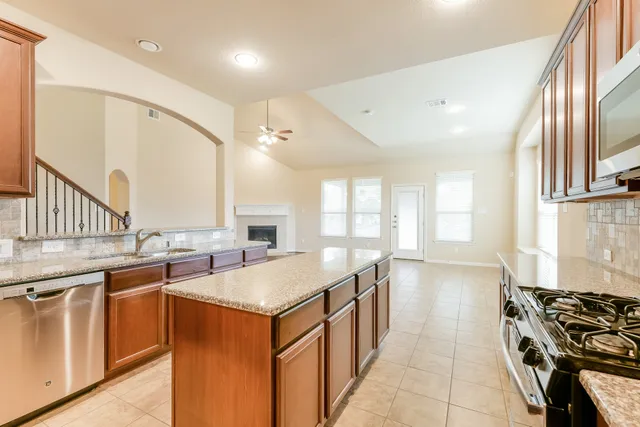 a kitchen with a sink stove and cabinets