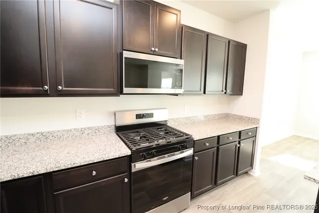 a kitchen with granite countertop stainless steel appliances and cabinets
