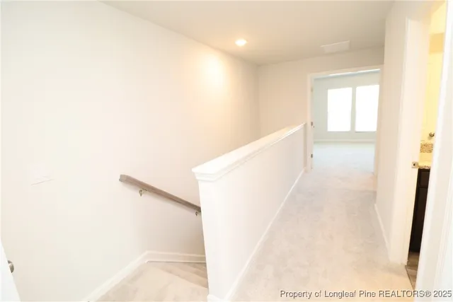 a view of a hallway with stairs