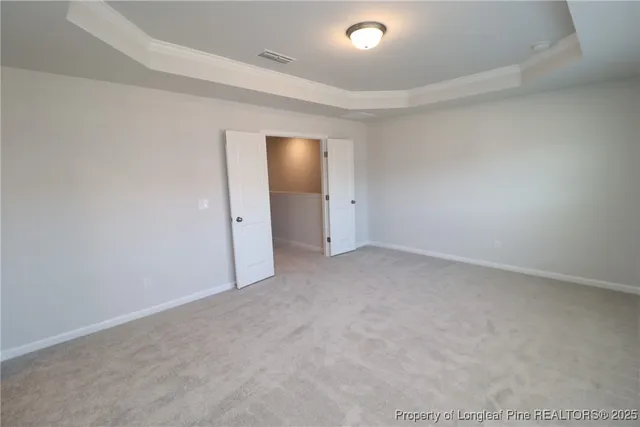 an empty room with closet and mirror