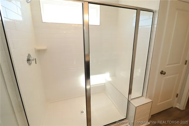 a bathroom with a glass shower door