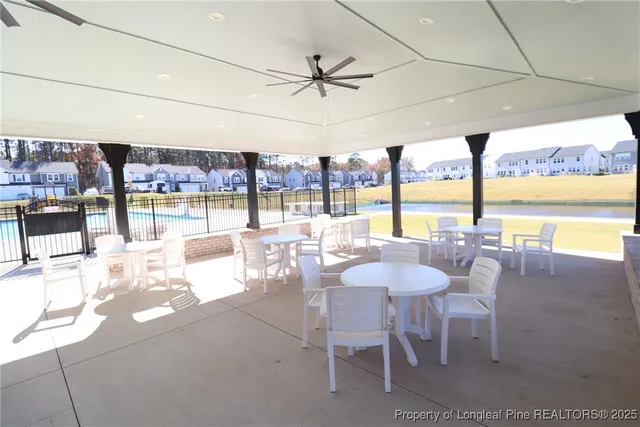 a dining room with furniture and a floor to ceiling window