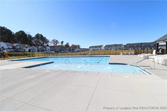 a view of a swimming pool and an outdoor seating