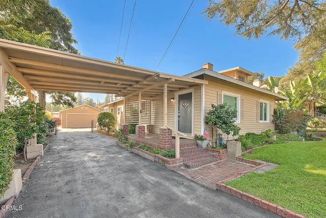 a view of a house with backyard and a garden