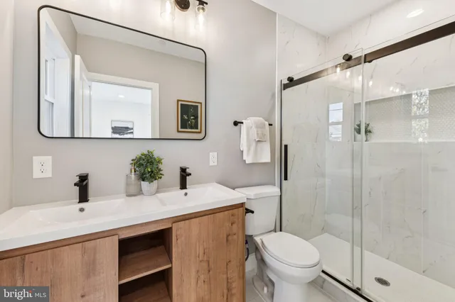a bathroom with a toilet sink and shower