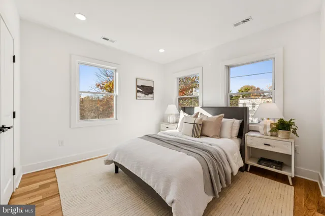 a bedroom with a bed and a painting on the wall