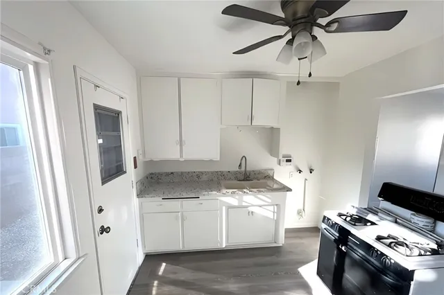 a kitchen with stainless steel appliances a white stove top oven and a refrigerator