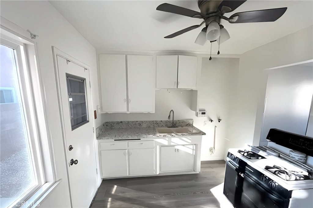 4603 Jurupa Avenue Riverside, CA 92506 - Photo 5 of 8 a kitchen with stainless steel appliances a white stove top oven and a refrigerator