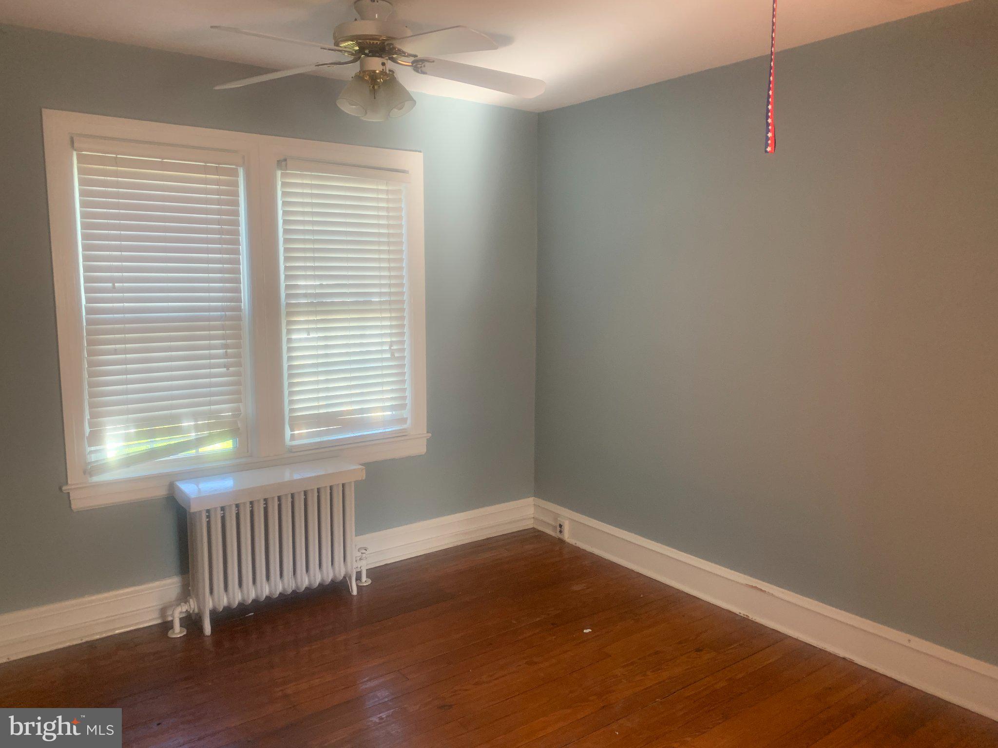 915 Stone Road, Unit A Laurel Springs, NJ 08021 - Photo 11 of 13 a view of an empty room with wooden floor and a window