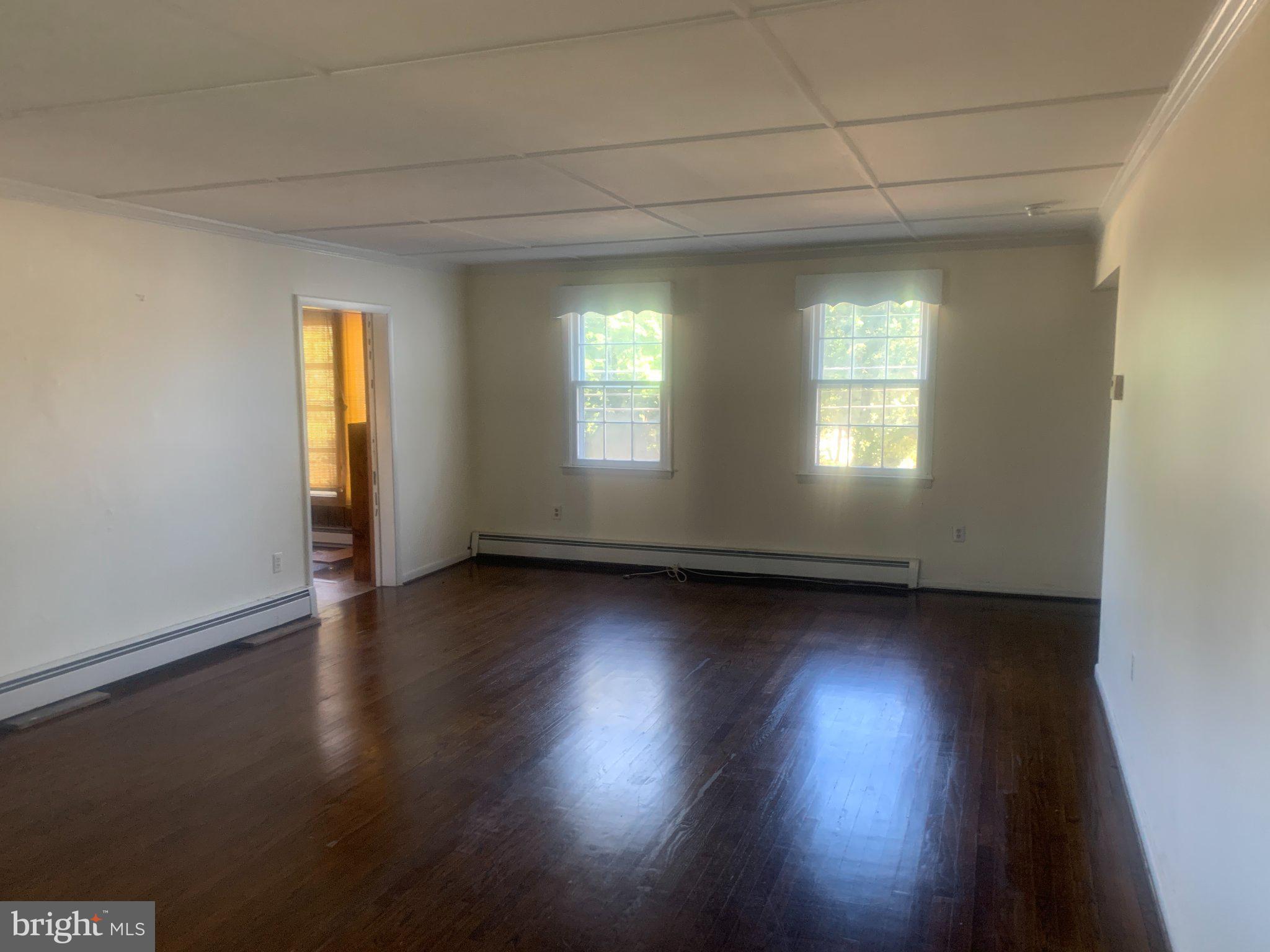 915 Stone Road, Unit A Laurel Springs, NJ 08021 - Photo 4 of 13 an empty room with wooden floor and windows