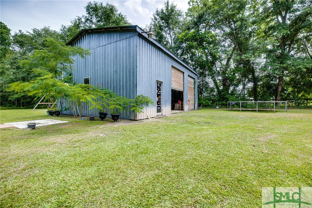 8082 Arcola Road Brooklet, GA 30415 - Photo 9 of 48 26' x 40' workshop on slab w/ power (view from bac