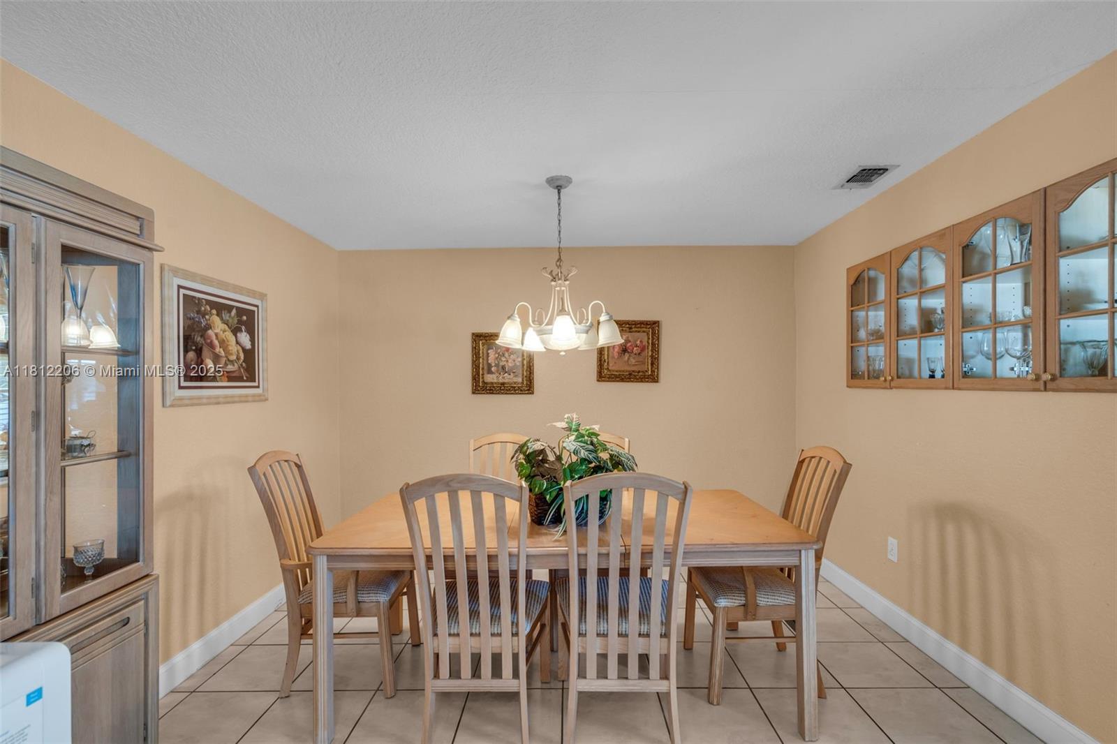 17550 Southwest 59th Court Southwest Ranches, FL 33331 - Photo 13 of 51 a dining room with furniture a potted plant and wooden floor