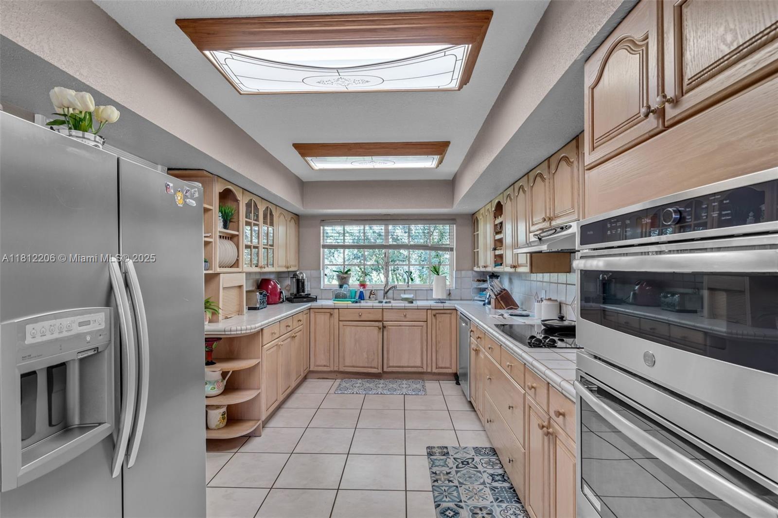 17550 Southwest 59th Court Southwest Ranches, FL 33331 - Photo 15 of 51 a kitchen with stainless steel appliances a stove a sink and a refrigerator