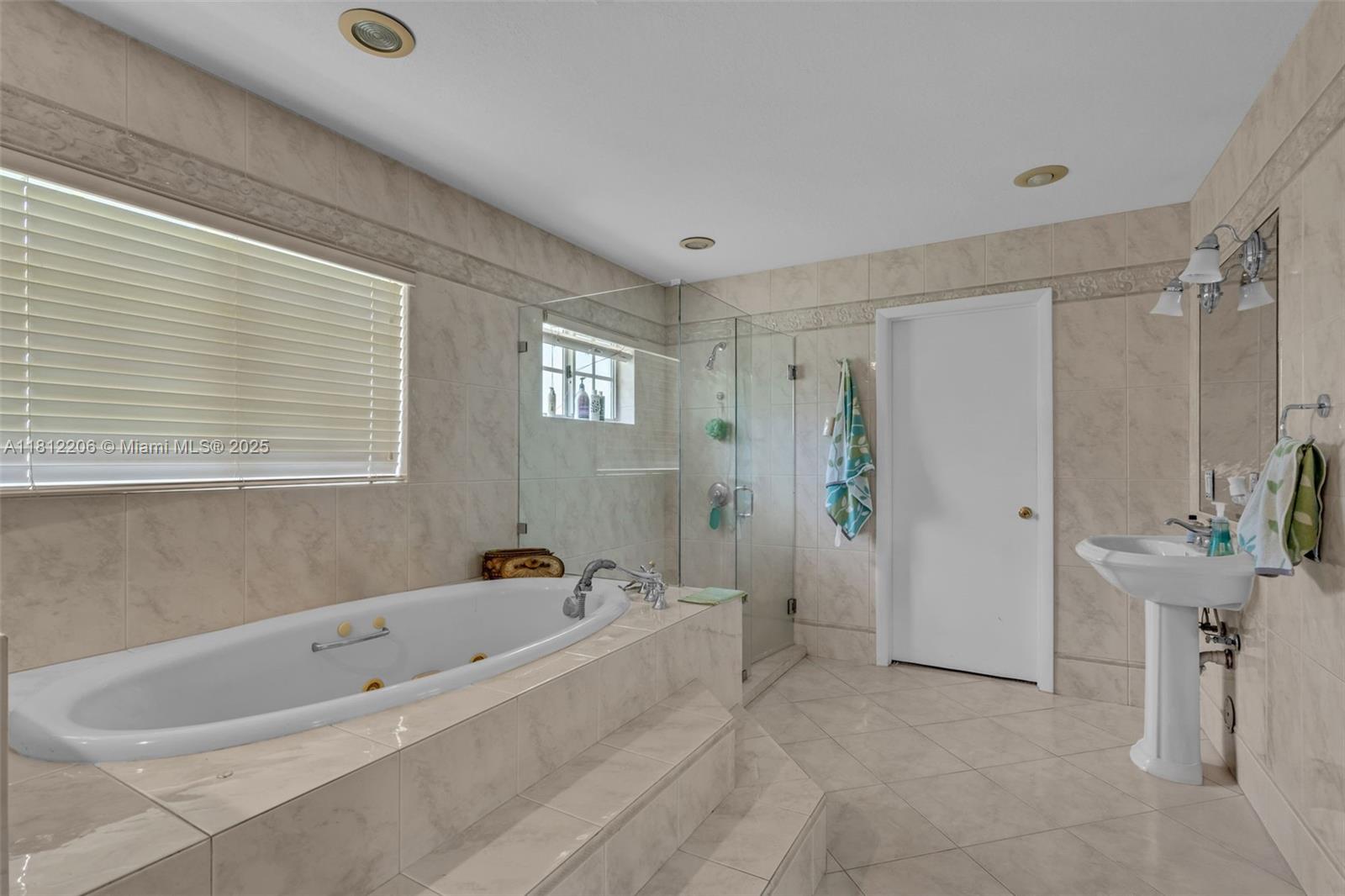 17550 Southwest 59th Court Southwest Ranches, FL 33331 - Photo 24 of 51 a bathroom with a tub a window and a shower