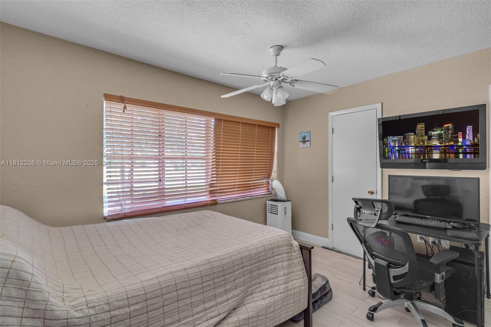 17550 Southwest 59th Court Southwest Ranches, FL 33331 - Photo 25 of 51 a bedroom with a bed and a desk