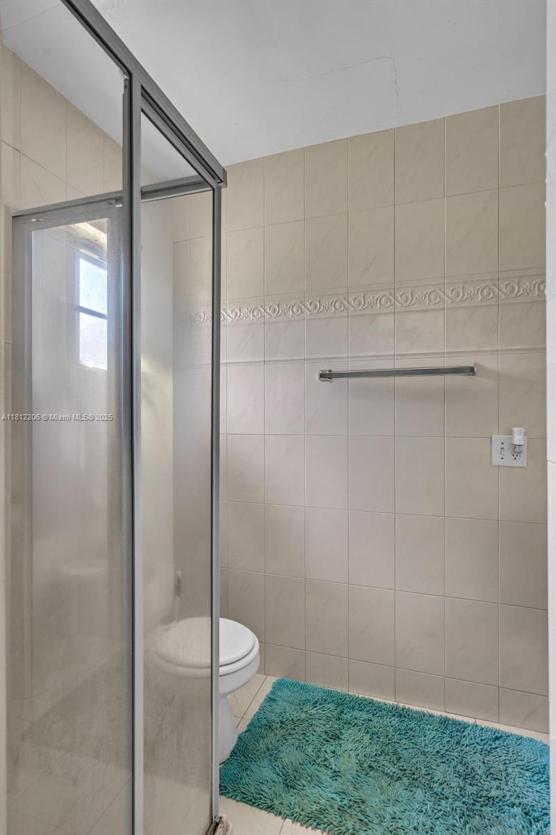 17550 Southwest 59th Court Southwest Ranches, FL 33331 - Photo 26 of 51 a bathroom with a shower and a toilet