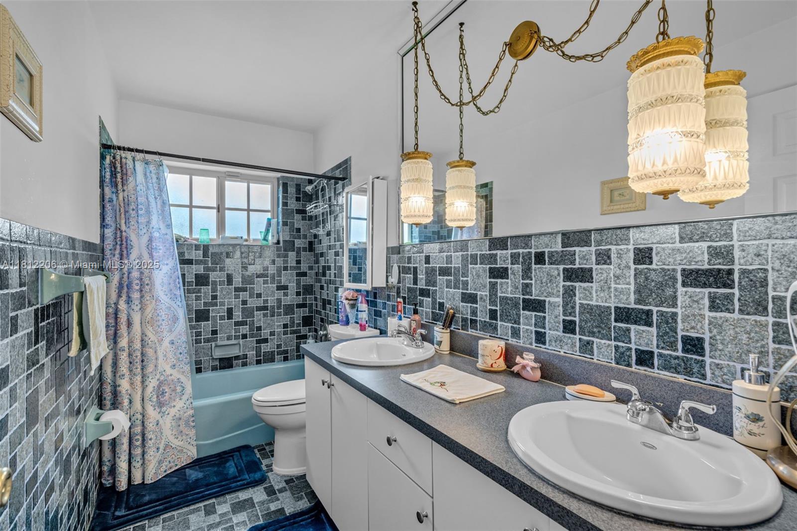 17550 Southwest 59th Court Southwest Ranches, FL 33331 - Photo 27 of 51 a bathroom with a sink a toilet a mirror and shower
