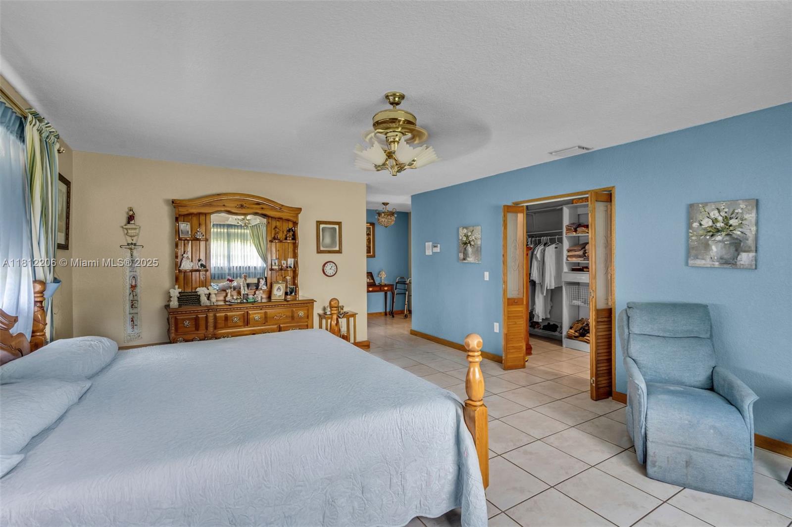 17550 Southwest 59th Court Southwest Ranches, FL 33331 - Photo 31 of 51 a bedroom with furniture and a chandelier