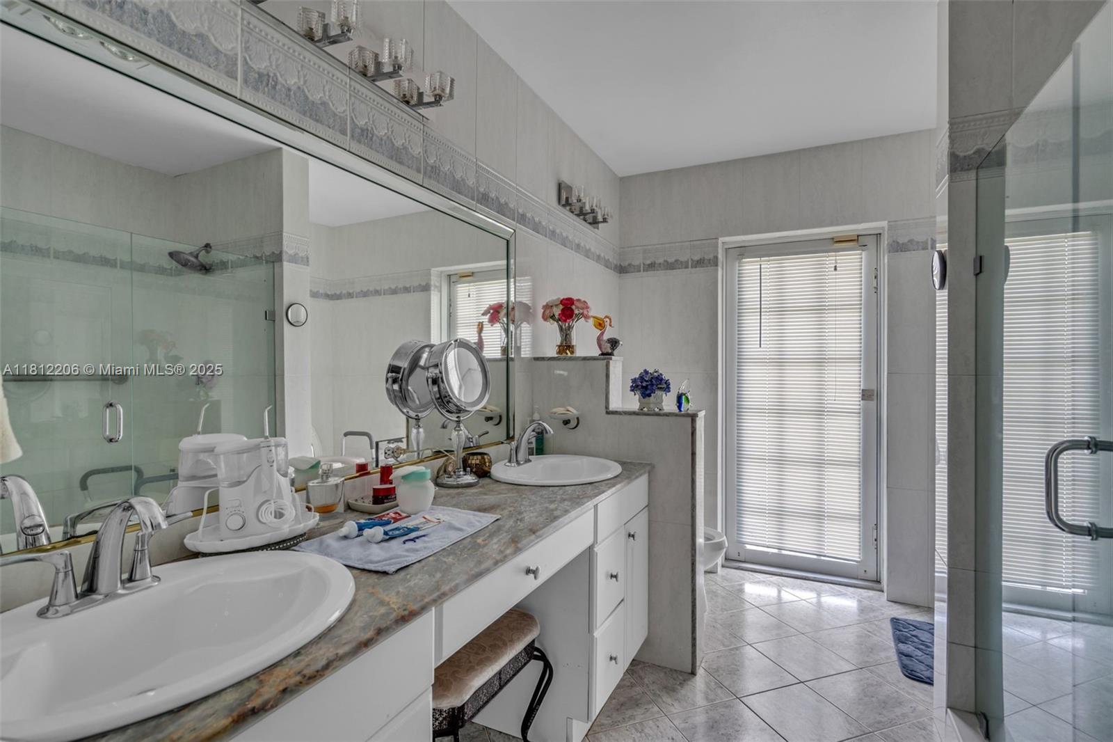 17550 Southwest 59th Court Southwest Ranches, FL 33331 - Photo 33 of 51 a bathroom with a sink mirror and shower