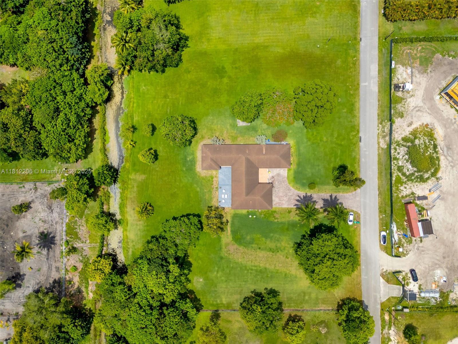 17550 Southwest 59th Court Southwest Ranches, FL 33331 - Photo 50 of 51 view of a garden with a building in the background