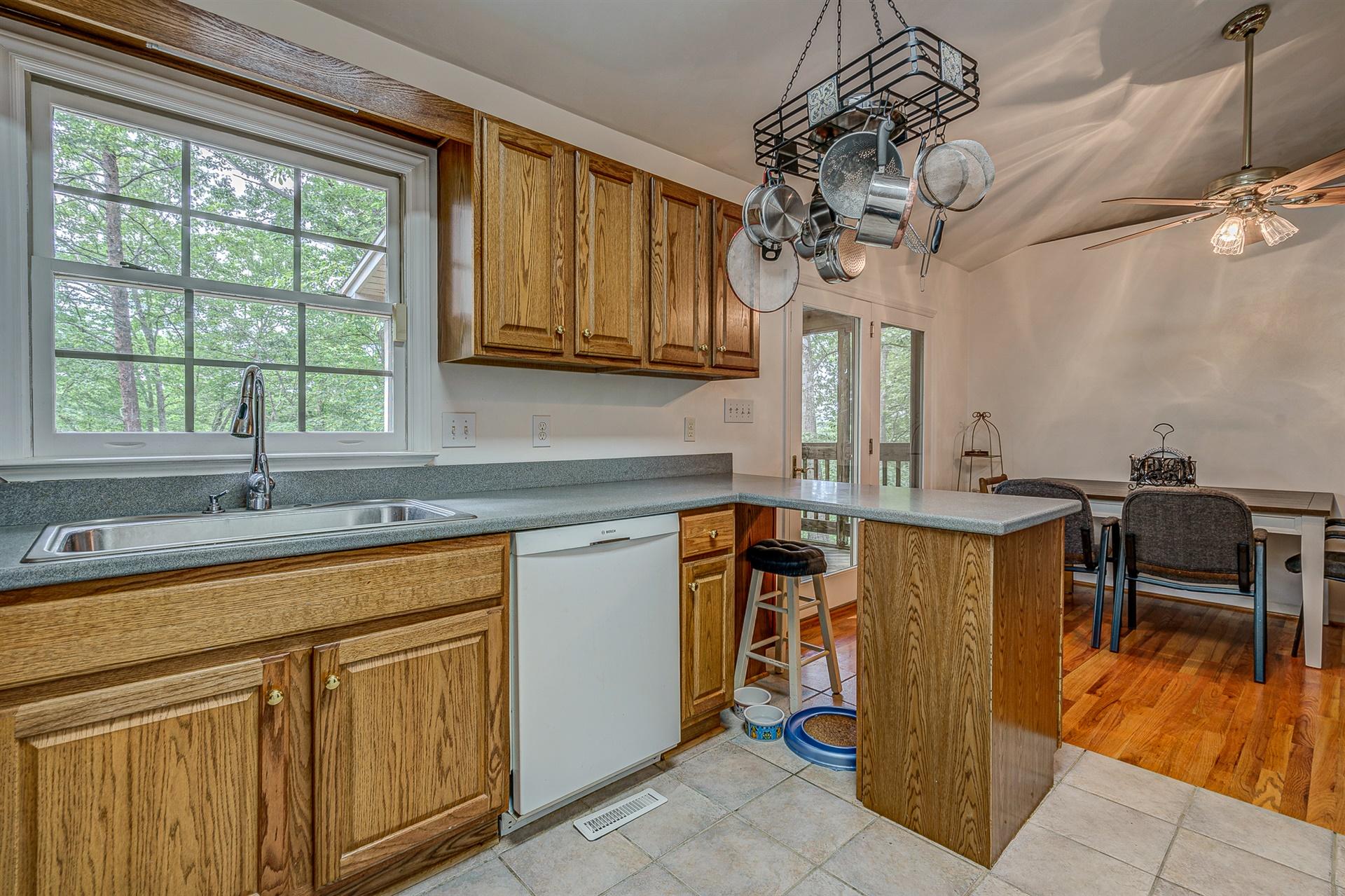 684 Northridge Road Hardy, VA 24101 - Photo 14 of 75 a kitchen with stainless steel appliances granite countertop a sink dishwasher and microwave with wooden floor