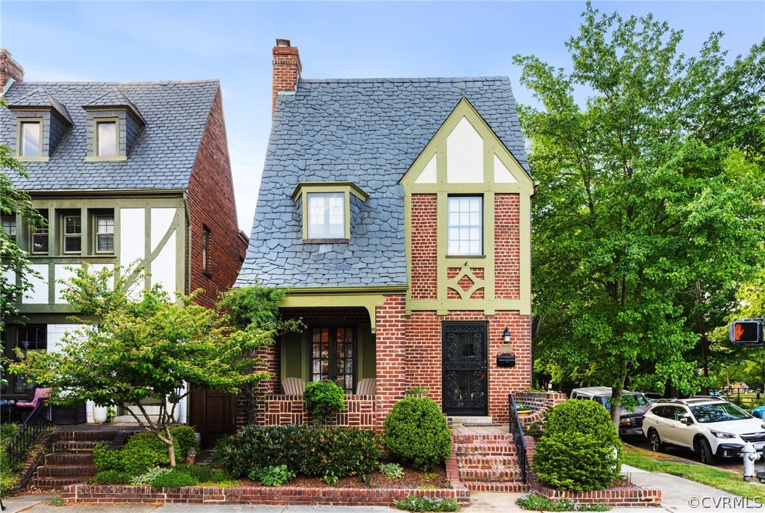 a front view of a house with plants and garage