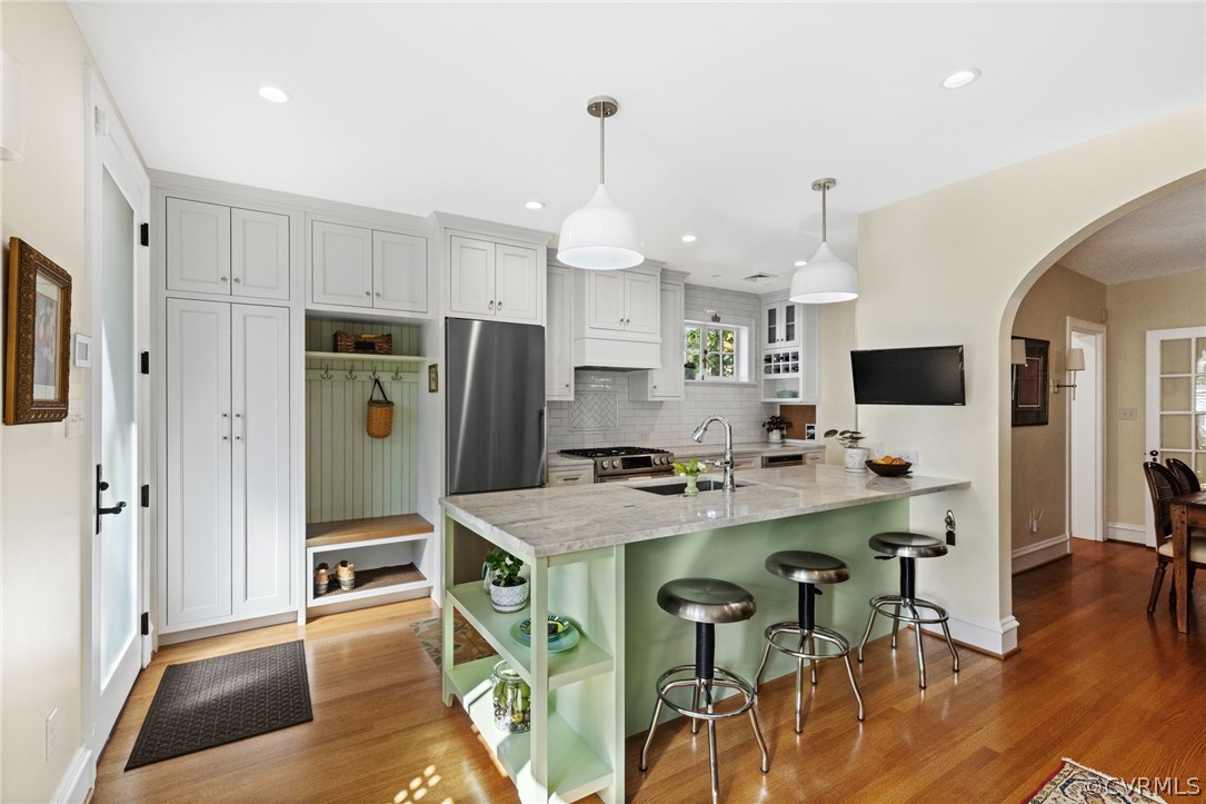 428 Roseneath Road Richmond, VA 23221 - Photo 16 of 40 a kitchen with stainless steel appliances a dining table chairs refrigerator and microwave