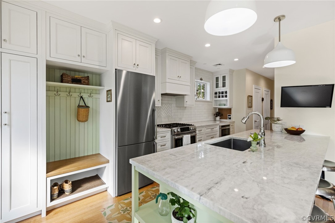 428 Roseneath Road Richmond, VA 23221 - Photo 17 of 40 a kitchen with stainless steel appliances granite countertop a refrigerator and a stove top oven