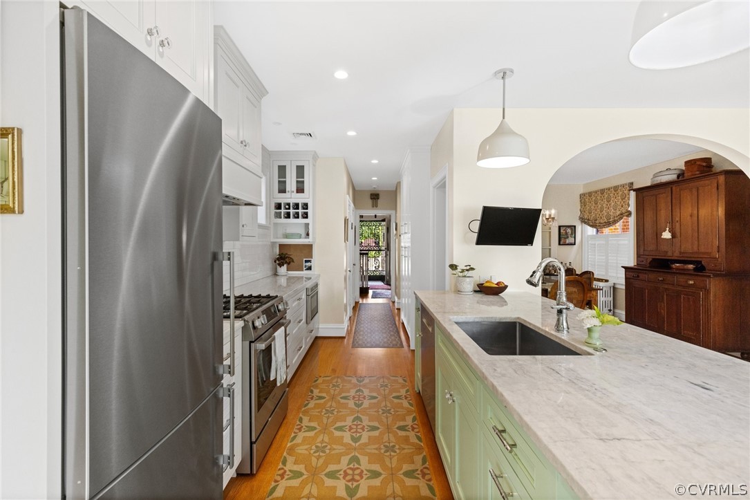 428 Roseneath Road Richmond, VA 23221 - Photo 18 of 40 a kitchen with stainless steel appliances kitchen island granite countertop a refrigerator and a sink
