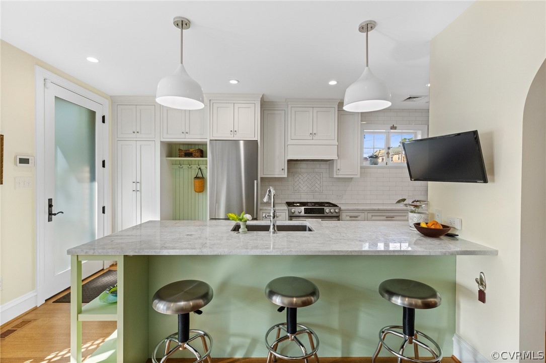 428 Roseneath Road Richmond, VA 23221 - Photo 19 of 40 a kitchen with stainless steel appliances granite countertop a sink a stove a refrigerator a center island and cabinets