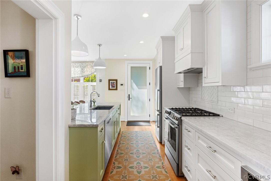 428 Roseneath Road Richmond, VA 23221 - Photo 23 of 40 a kitchen with stainless steel appliances granite countertop a stove a sink and a refrigerator