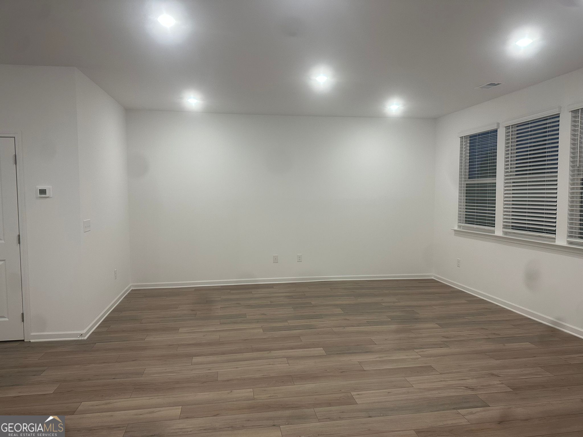 4281 Marsha Street Doraville, GA 30360 - Photo 11 of 38 an empty room with wooden floor and windows