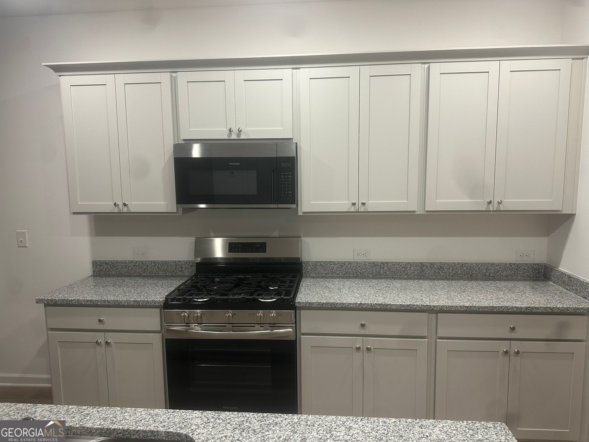 4281 Marsha Street Doraville, GA 30360 - Photo 17 of 38 a kitchen with granite countertop white cabinets and stainless steel appliances