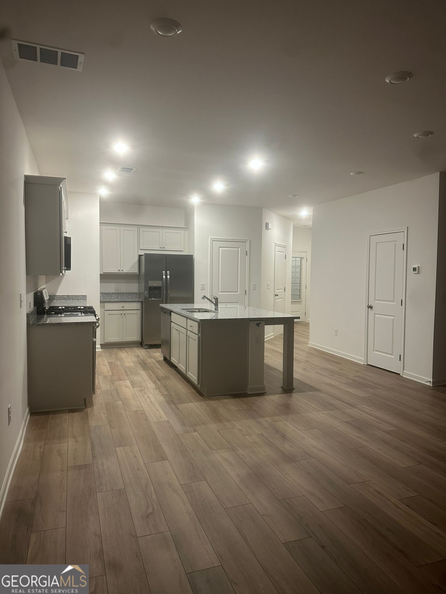 4281 Marsha Street Doraville, GA 30360 - Photo 28 of 38 a large kitchen with stainless steel appliances granite countertop a large counter top and a stove