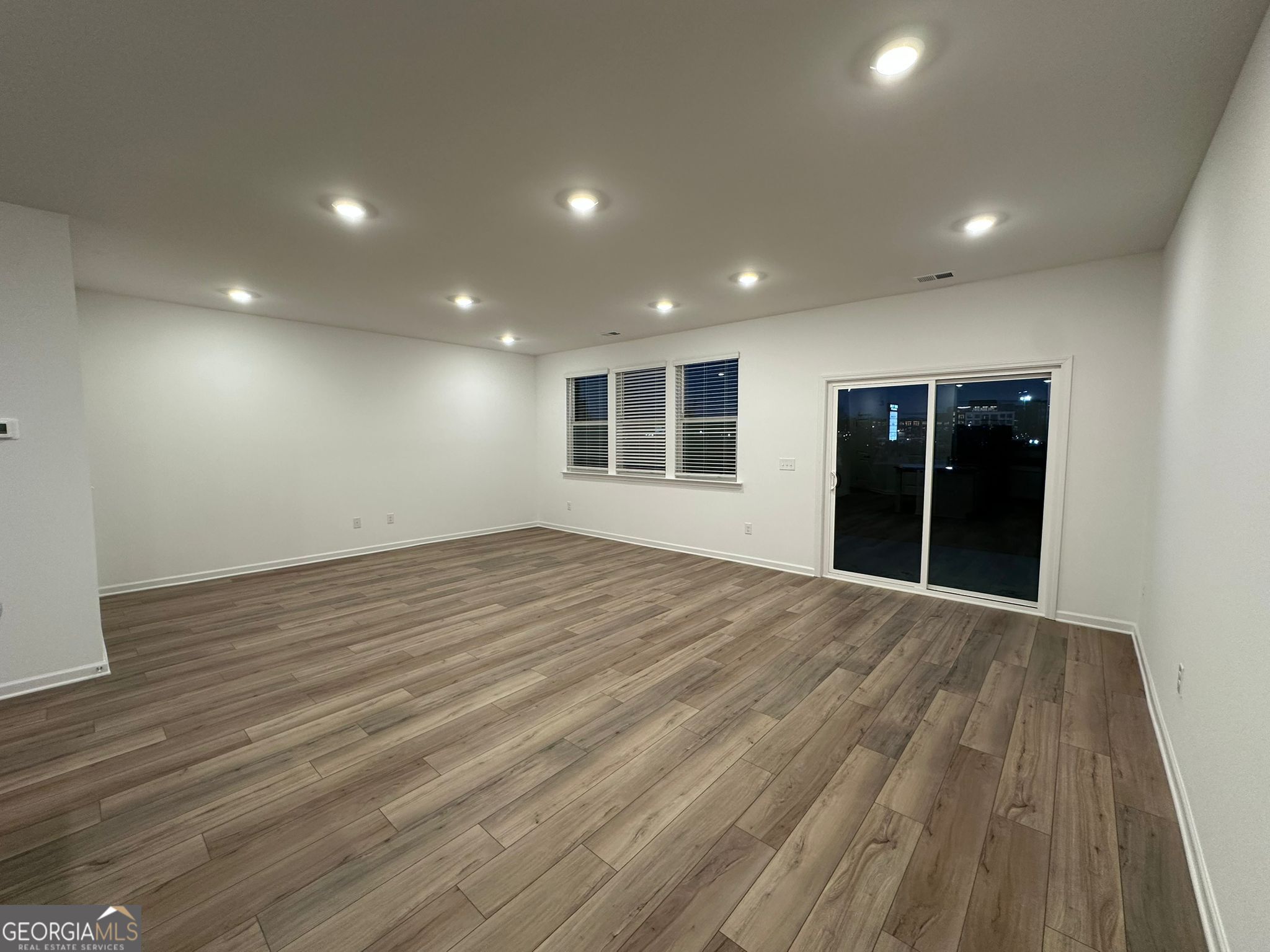 4281 Marsha Street Doraville, GA 30360 - Photo 8 of 38 a view of an empty room with wooden floor and a window