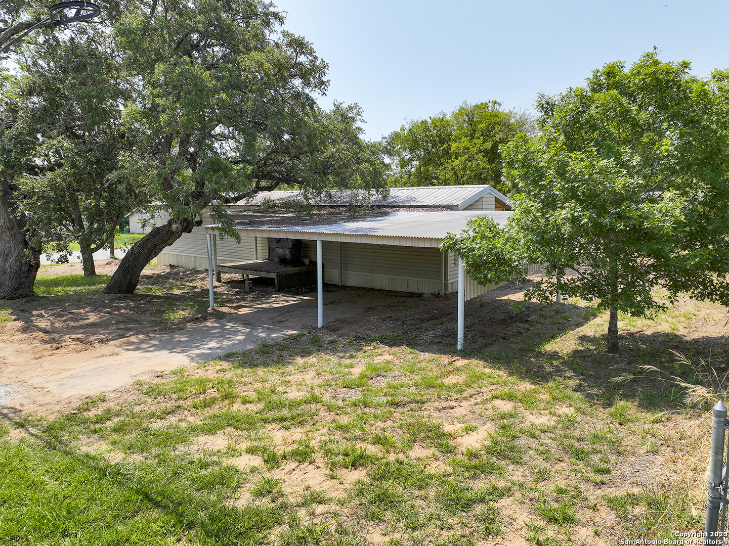 a view of a house with backyard porch and sitting area
