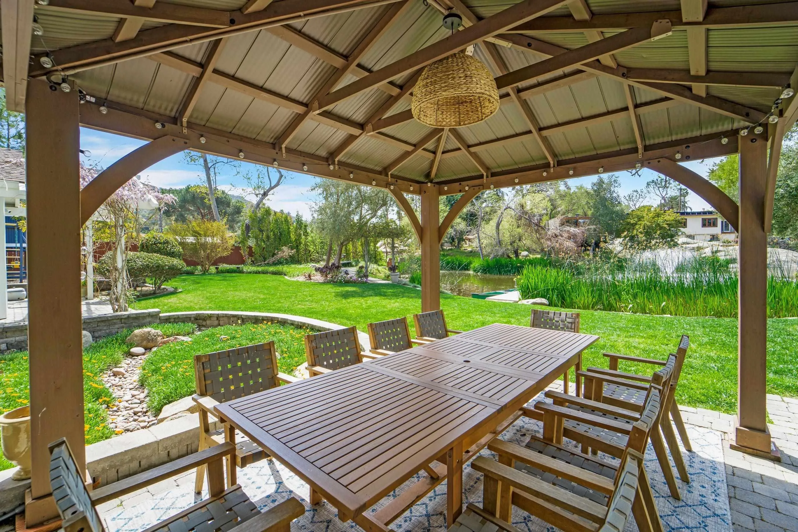 16163 Del Norte Poway, CA 92064 - Photo 34 of 41 a view of a patio with table and chairs under an umbrella with a small yard