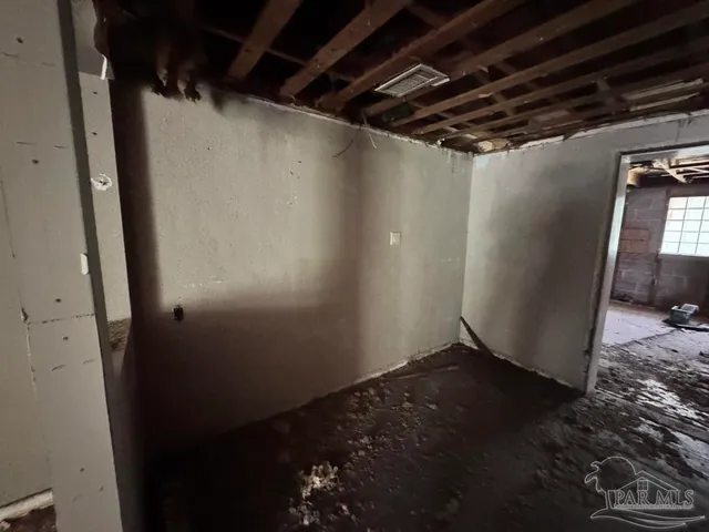 a utility room with wooden floor washer and dryer